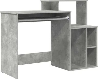 A concrete-gray computer desk with shelves.