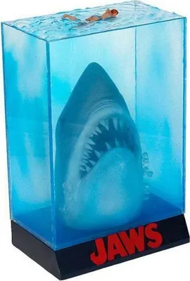 A 3D poster statue of a shark emerging from water with a swimmer above, featuring the "JAWS" logo.