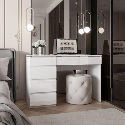 A modern bedroom with a white vanity desk and a laptop.