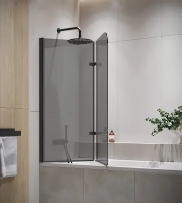 A modern bathroom with a bathtub and a shower screen.