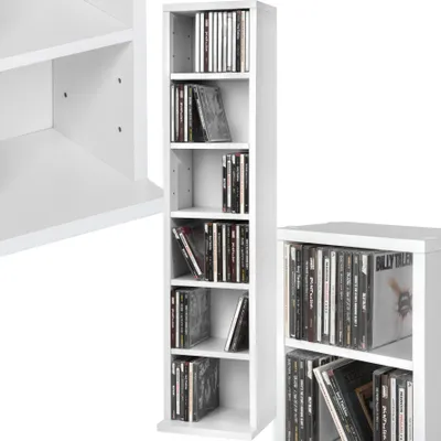A white, narrow, multi-shelf CD/DVD rack filled with CDs, shown from the front and a side angle. A portion of another white shelf unit is visible on the left.