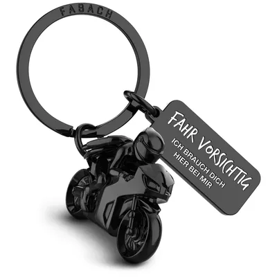 A black motorcycle keychain with a tag.