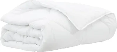 A white duvet folded and lying on a white background.
