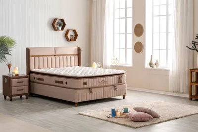 A bedroom scene featuring a bed, nightstand, and decorative elements.