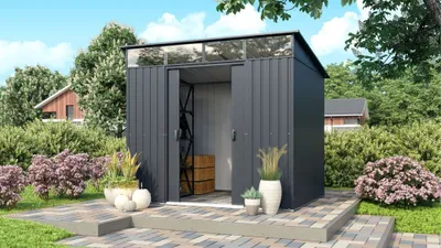 A modern garden shed with sliding doors, set in a landscaped garden with paving stones and plants.