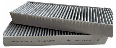 Two car cabin air filters are stacked on a white background.