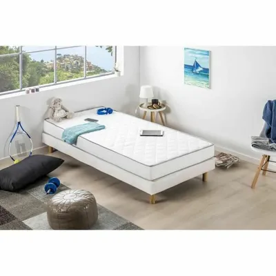 A bedroom scene with a single bed, mattress, and various accessories.