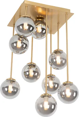 A modern chandelier with nine glass globes hanging from a gold square base.