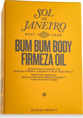 A close-up of the front of a yellow product box for Sol de Janeiro Bum Bum Body Firmeza Oil.