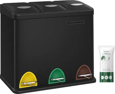 A black three-compartment trash can with colored pedals and a package of trash bags next to it.
