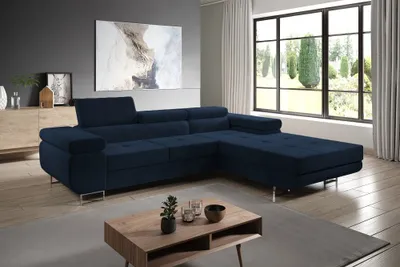 A modern living room with a navy blue sectional sofa, a coffee table, and a large window overlooking a garden.