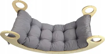 A Montessori rocking board with a gray cushion, shown from a slightly elevated front angle against a white background.