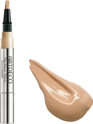 A makeup concealer pen and a swatch of concealer.