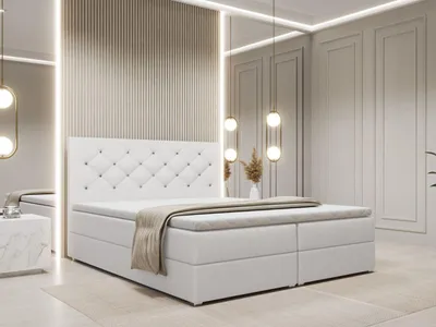A white boxspring bed with a tufted headboard is shown in a modern bedroom setting.