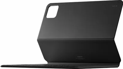 A black keyboard case for a tablet is shown from a side angle, propped open.