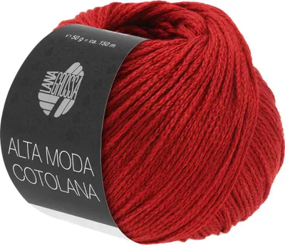 A ball of red yarn with a black label wrapped around it.
