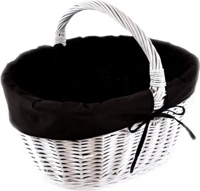 A white wicker basket with a black fabric lining and a black ribbon tie.