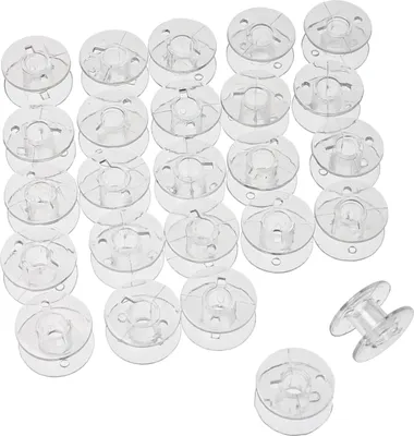 A collection of clear plastic bobbins for sewing machines, neatly arranged.