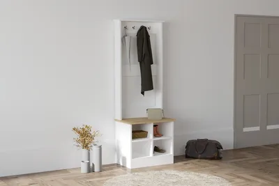 A hallway stand with coats and accessories in a room.