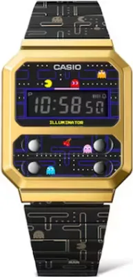 A close-up, front-facing view of a Casio x Pac-Man digital watch with a gold-tone case and a black band featuring Pac-Man graphics.