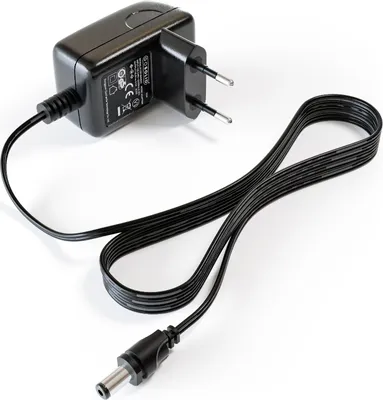 A black power adapter with a European plug and a black cable with a barrel connector, shown on a white background.