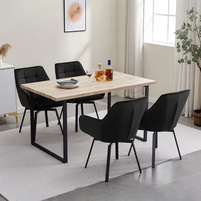 A dining set with four black chairs and a light wood table.