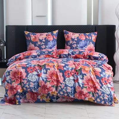 A bed with floral patterned bedding.