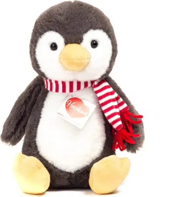 A plush toy penguin sitting on a white background.