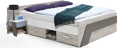 A modern bed with a nightstand and lamp.