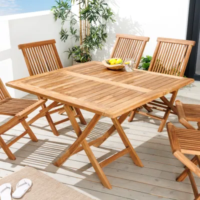 An outdoor patio setting with a wooden table and chairs.