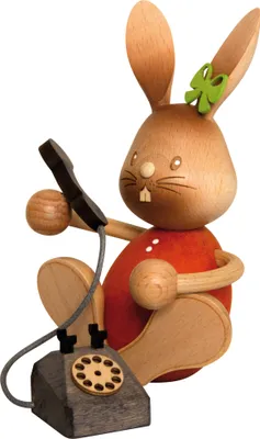 Produktbild von Drechslerei Kuhnert - Dekofigur Hase Stupsi mit Telefon - Größe ca. 11cm - 52235