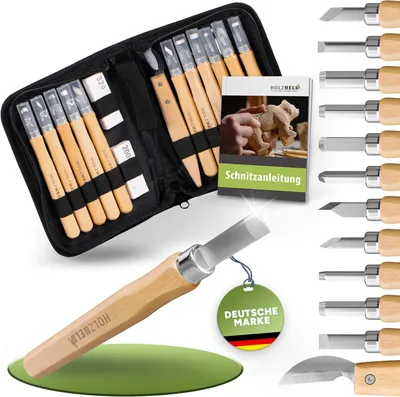 A set of wood carving tools laid out with a case and instruction booklet.