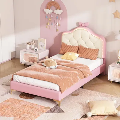 A child's bedroom with a pink bed and decorative elements.