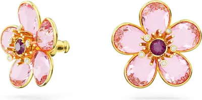 A pair of pink flower-shaped stud earrings with gold-tone settings and a purple center stone, displayed against a white background.