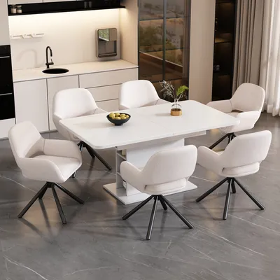 A modern dining room set with a white table and six beige chairs.