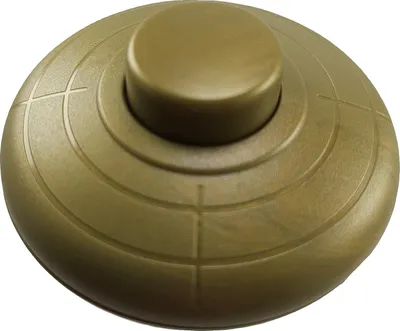 A close-up, studio shot of a gold-colored foot switch.
