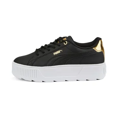 A black Puma sneaker with a white platform sole and gold accents.