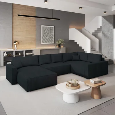 A modern living room with a large sectional sofa, coffee tables, and a staircase.