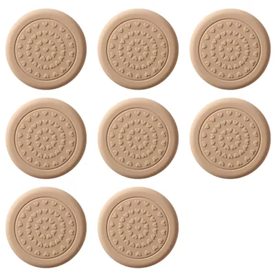 A collection of beige, circular anti-slip pads with a heart pattern arranged in concentric circles.