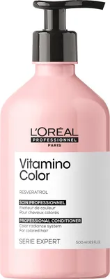 A pink bottle of L'Oréal Professionnel Vitamino Color Resveratrol Conditioner with a black pump dispenser, isolated on a white background.