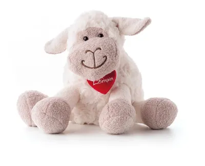 A plush sheep toy sitting on a white background.