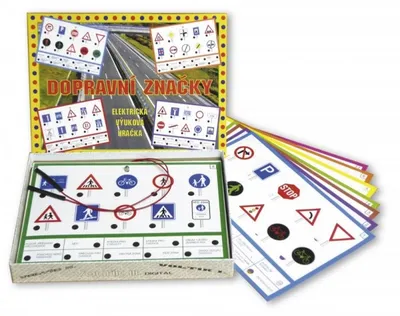 A product box and its contents, including a circuit board with traffic signs and several sheets of traffic signs.