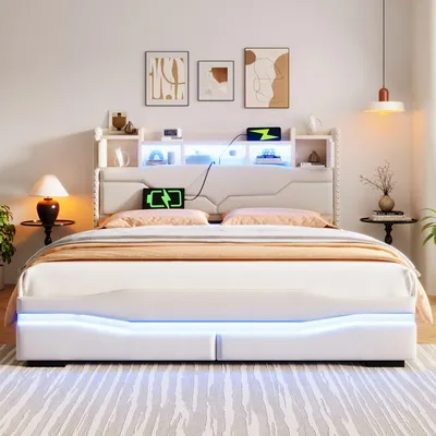 A modern bedroom with a white upholstered bed featuring LED lighting and a headboard with storage.