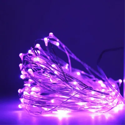 A close-up shot of a tangled string of purple LED lights.
