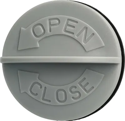 A close-up view of a gray plastic cap with embossed text indicating 'OPEN' and 'CLOSE' with directional arrows.