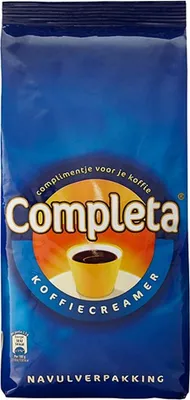 A blue bag of coffee creamer with branding and product information.