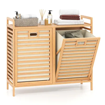 A bamboo laundry sorter with two compartments, one open with clothes inside and one closed.