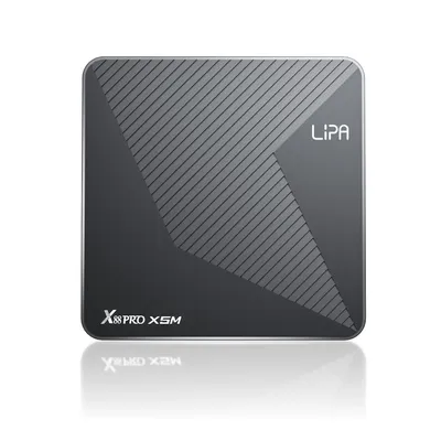 A studio shot of a black and gray streaming box with a reflective surface.