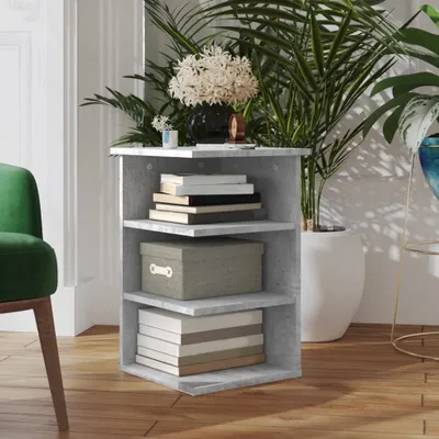 A corner of a room with a small shelf unit, a green chair, and plants.
