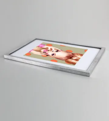 A framed picture is shown at an angle on a light gray surface.
